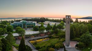 An aerial view of Walter C Koerner Library at sunset with the Ladner clock tower in the foreground.