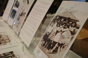 Photograph of young Indigenous residential school students in a display case.